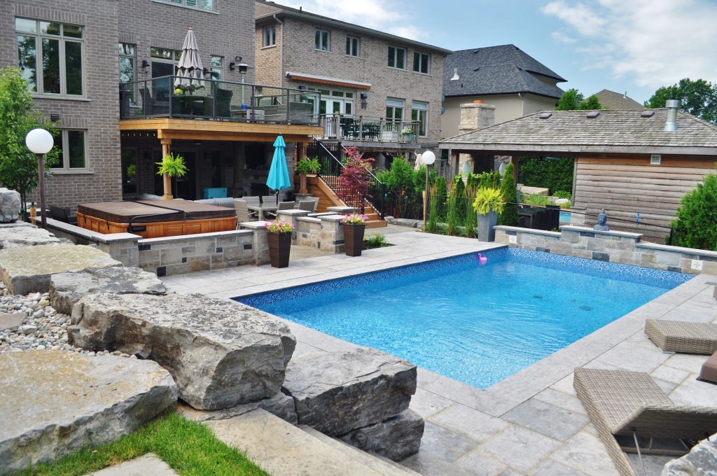 Pool, hot tub, stone retaining wall, privacy screen, upper deck
