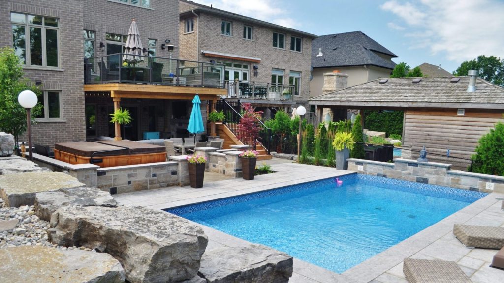 Pool, hot tub, stone retaining wall, privacy screen, upper deck